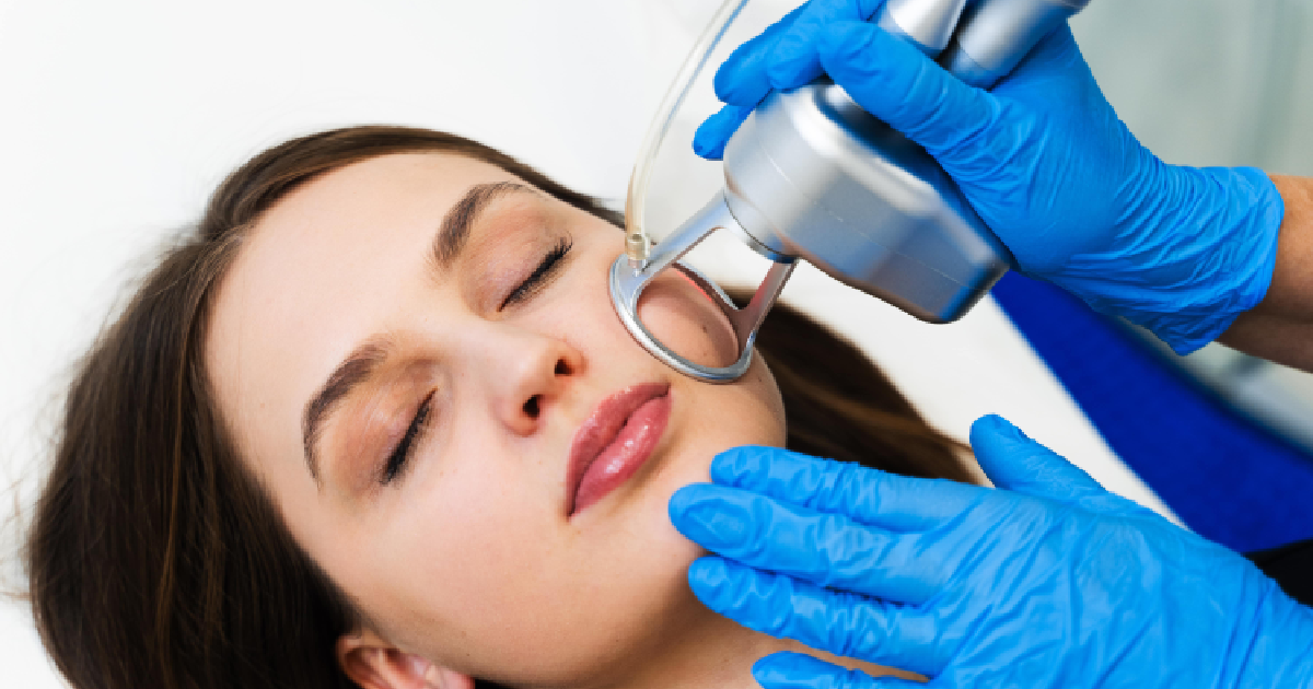 Woman receiving Tetra CO2 laser treatment on cheek in Manchester, NH