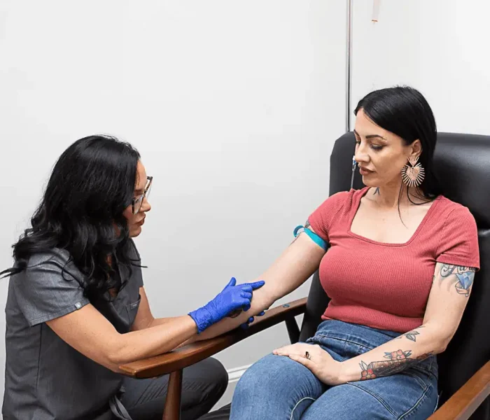 Female receiving IV Therapy for health and wellness at The Alchemy Clinic in Manchester, NH